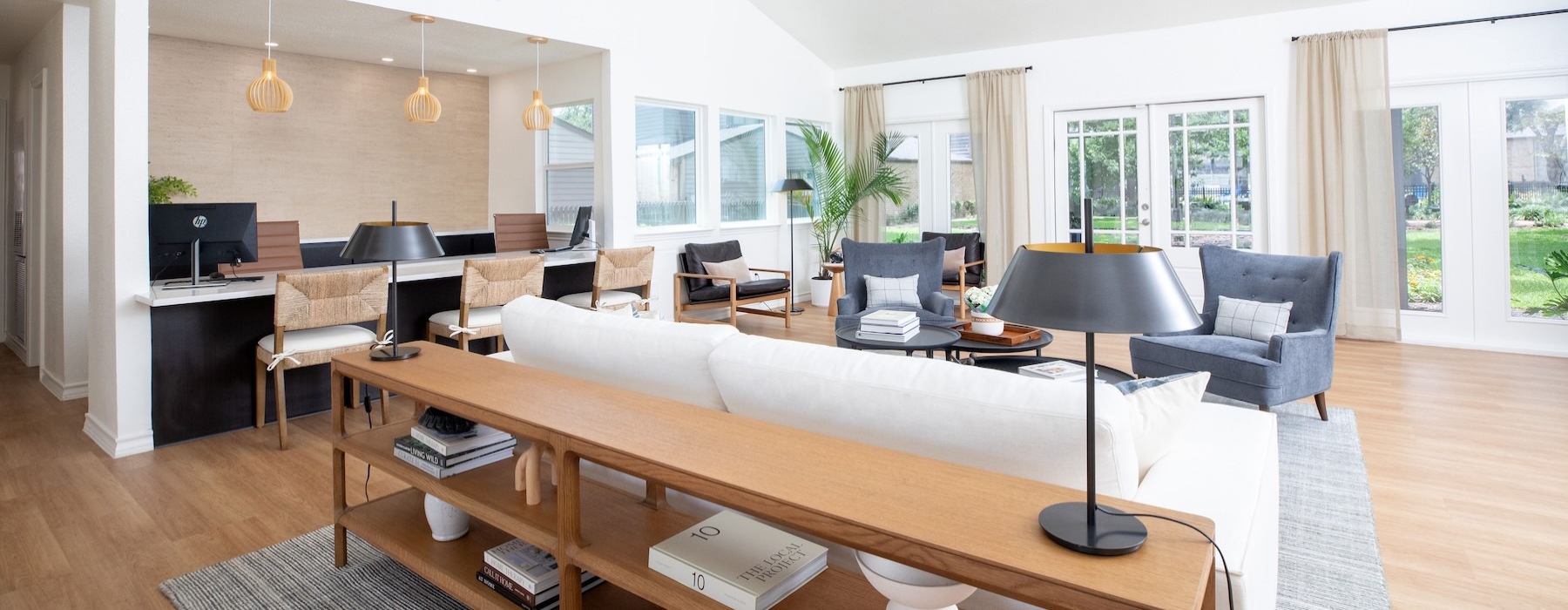 a clubhouse room with couches, a large table and chairs
