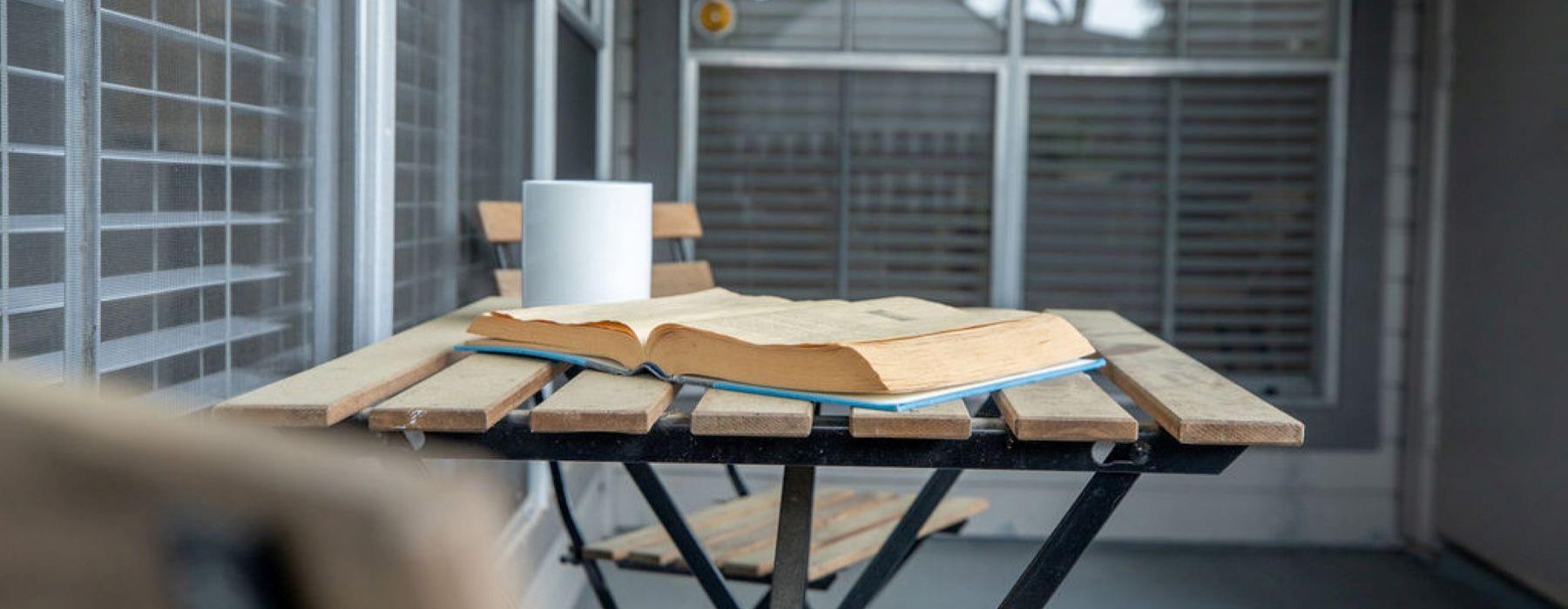 a balcony with a table and chairs