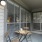 a patio area with a table and chairs